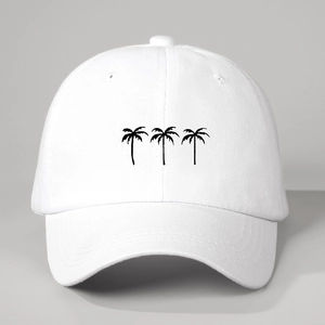 Close-up of white baseball cap with three black palm tree prints on fabric