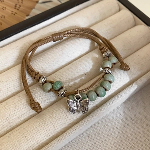 Handmade woven ceramic bead bracelet with silver butterfly charm in New Chinese style