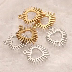 Detailed view of hollow heart charms with sunray edges in gold and silver steel finish