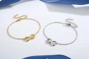 Detail of gold and silver infinity symbol bracelets with adjustable lobster clasp closure
