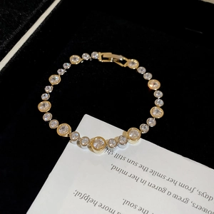 Macro view of crystal encrusted stainless steel bracelet on black velvet luxury gift card