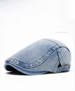 Detail view of washed blue denim beret with adjustable metal buckle and twill texture