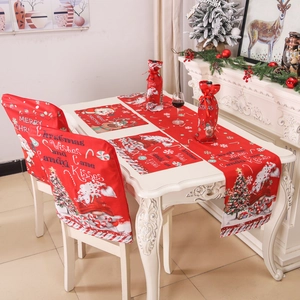 Christmas dining decor set with Santa and reindeer patterns on red chair covers and placemats
