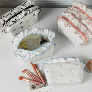 Sweet quilted ruffled makeup bags with bow patterns in black, pink, and blue colors
