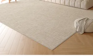 Detailed top view of beige woven texture carpet on light wood herringbone flooring