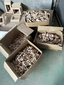 Bulk unfinished wooden animal carvings and square frames stored in factory warehouse boxes
