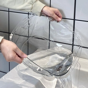 Elegant thick transparent PET washbasin for home use shown pouring water in a sink