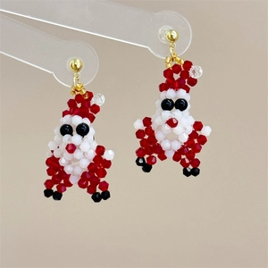 Detailed macro view of handmade Santa Claus beaded earrings with festive crystal accents