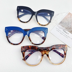 Detailed view of oval cat-eye glasses frames with silver rivet accents in various colors