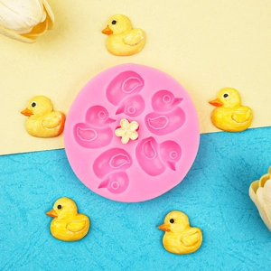 Pink silicone mini duck cake mold with yellow duckling fondant decorations