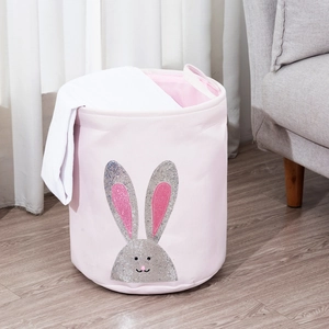 Macro view of pink fabric laundry basket featuring a sparkling silver sequin bunny design