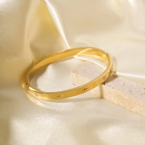 Elegant 18k gold plated stainless steel bangle featuring star-shaped crystal settings