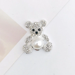 Detailed view of a silver bear pendant featuring a large pearl and sparkling rhinestones
