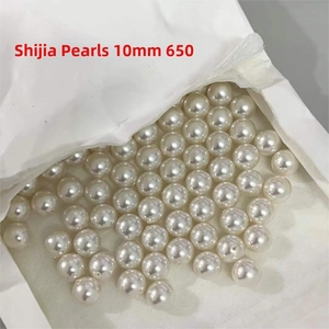 Close-up of bulk 10mm round cream pearls for jewelry making in paper packaging