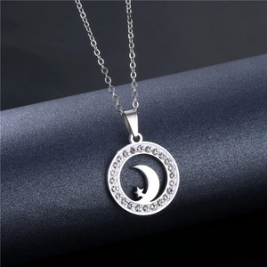 Macro shot of silver crescent moon and star pendant with sparkling cubic zirconia inlay