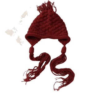 Fashionable dark red hand-knitted beanie with tassels for women, warm winter headwear