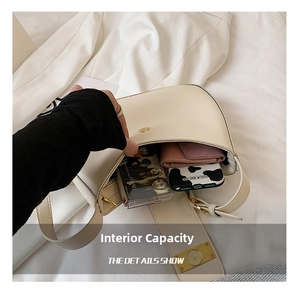 Detail showing the large interior capacity of this cream baguette bag with phone and wallet