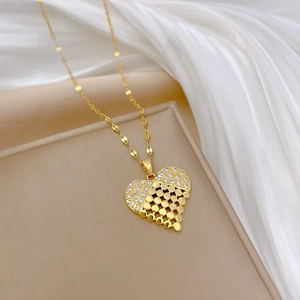 Luxurious gold heart pendant necklace with shimmering crystals and mesh pattern