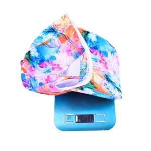 Colorful feather print tie-dye baseball cap shown on a digital scale weighing 71g
