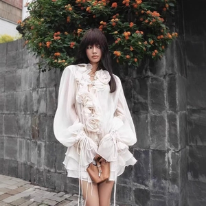 Elegant white chiffon long-sleeved top with 3D floral accents and ruffled details