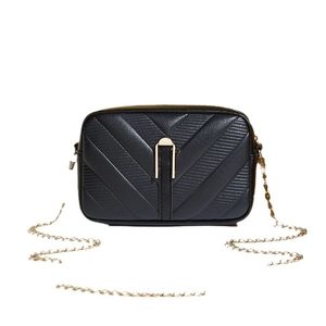 Elegant black quilted crossbody bag with V-shaped patterns and gold chain strap