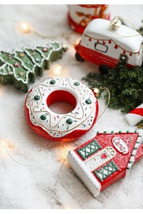Detailed view of colorful painted Christmas ornaments with glitter in snowy scene