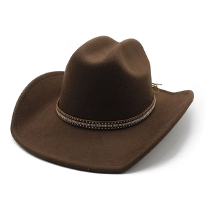 Detail of dark brown cowboy hat with metallic rivets and rhinestone decorative band