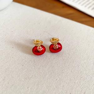 Detail of red fortune bag earrings with 18K gold plating and sparkling crystal accents