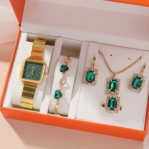 Golden jewelry set with green stones including watch and necklace in orange gift box