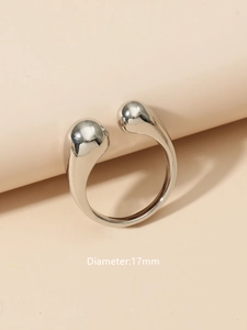 Detail view of adjustable brass ring with dual sphere ends and 17mm diameter size