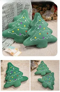 Detail of plush Christmas tree cushions with festive embroidery in a cozy home setting