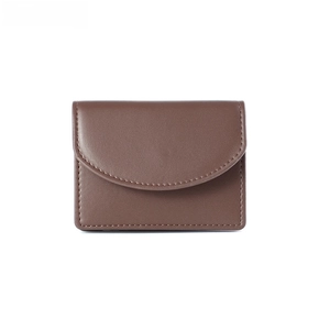 Detailed view of brown leather short wallet with arc flap and neat edge stitching