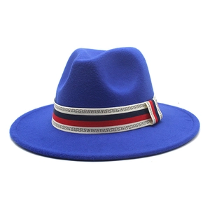 Detail of royal blue fedora hat featuring a red, white, and blue geometric woven band
