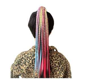 Close-up of child colorful braided hairpiece with gradient neon colors from yellow to blue