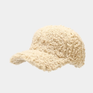 Close-up of thick cream faux lamb wool texture on winter baseball cap for women