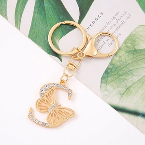 Detailed view of golden butterfly letter C keychain with sparkling crystal rhinestones