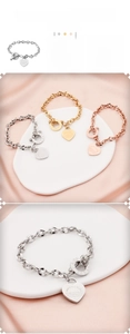Detailed view of heart pendants in gold, silver, and rose gold with OT clasp on link chains