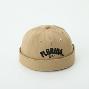 Detail of khaki melon cap featuring FLORIDA 1845 embroidery and cotton twill texture
