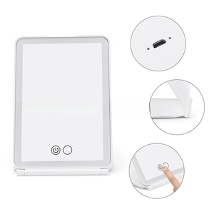 Detail view of foldable LED makeup mirror showing USB port and touch control switch