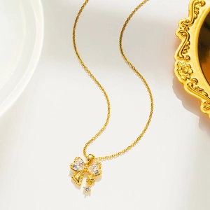 Close-up of gold butterfly pendant with sparkling zircon crystals on a delicate chain