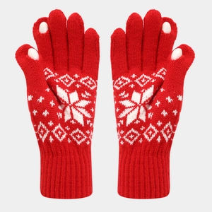 Detail of red knitted gloves with white snowflake patterns and touchscreen finger openings