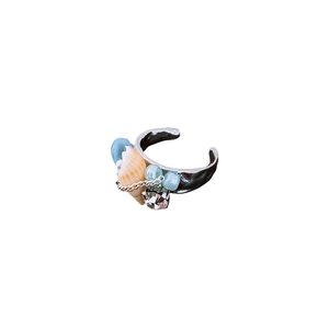 Bohemian sea shell and blue pearl open ring with chain detail on white background