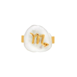 Close-up of golden Scorpio zodiac ring featuring a unique irregular white pearl inlay