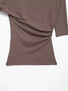 Detailed view of the dark brown side-pleated fabric with elastic knitted texture