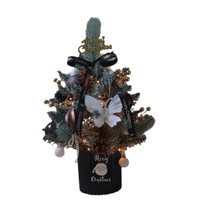 Mini tabletop Christmas tree with gold ornaments, pine cones, and LED lights on white background