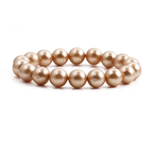 Elegant champagne gold bead bracelet for women featuring round pearls on a white background