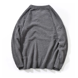 Macro shot of dark grey knit sweater texture showing soft fuzzy fabric details