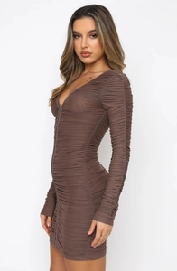 Side view of brown ruched long sleeve mini dress highlighting elastic textured fabric