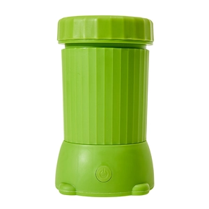 Portable electric pet paw cleaner in bright green with automatic cleaning button
