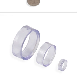 Three sizes of transparent acrylic rings for jewelry display with a coin for scale reference
